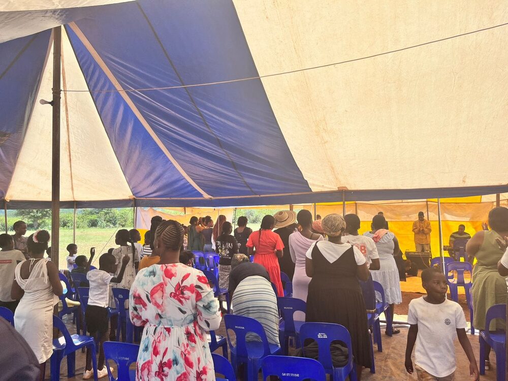 Congregation gathered under the tent at Nweli
